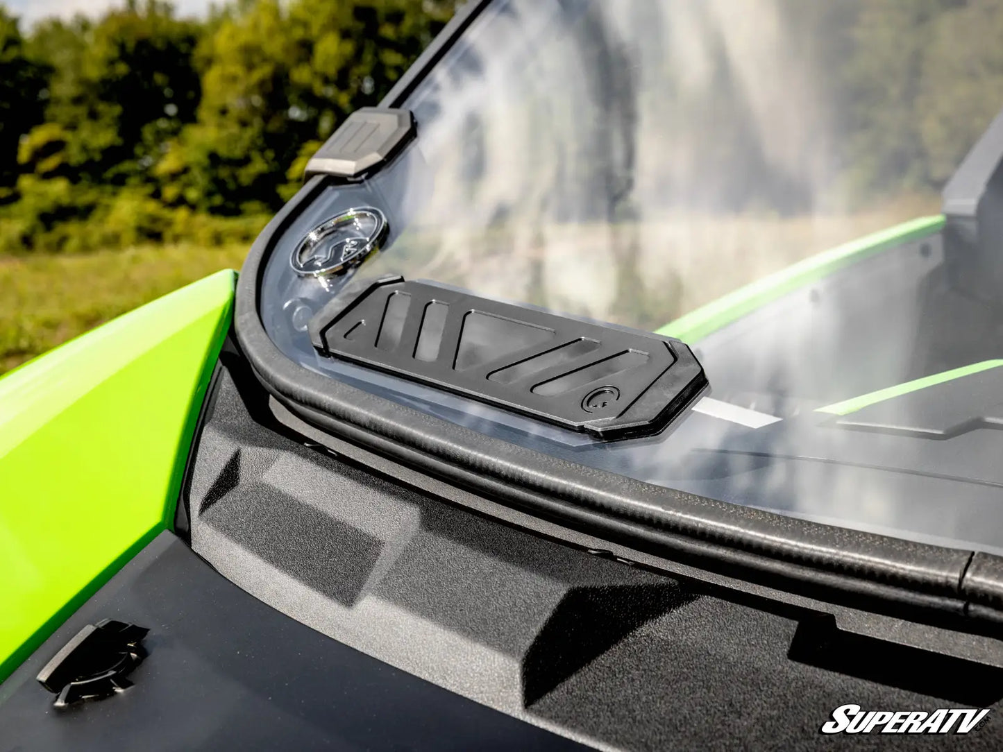 Close-up of a SuperATV product on a vehicle with a blurred natural background