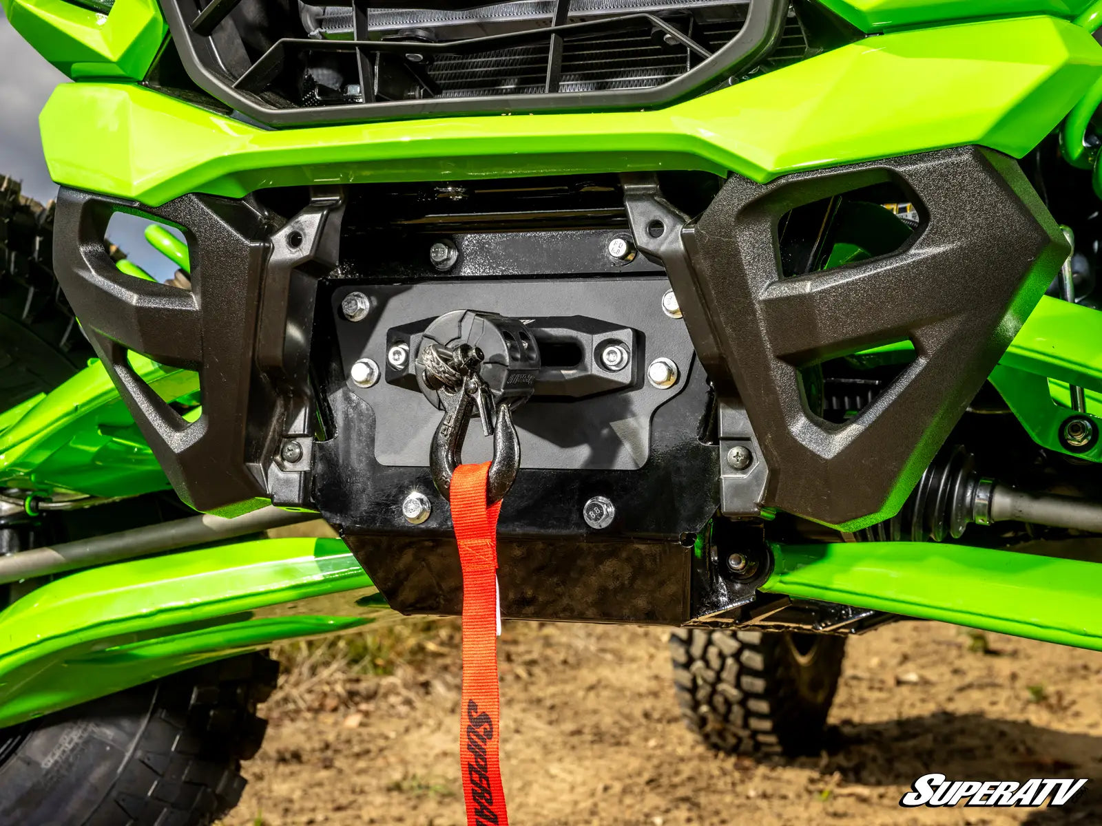 Close-up of a green ATV with a black front bumper and red strap, featuring the SuperATV logo.