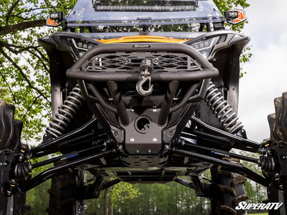 Close-up of an off-road vehicle with a SuperATV logo in a forest setting
