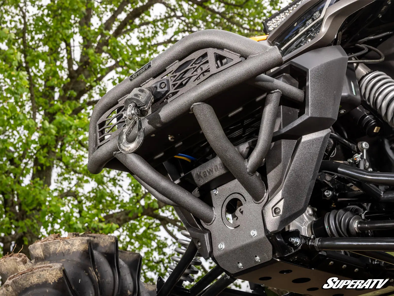 Close-up of an ATV bumper with 'SuperATV' branding against a natural background.