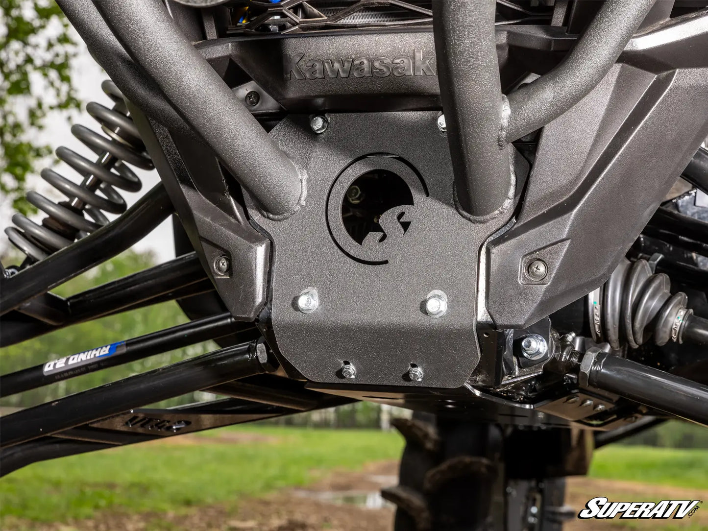 Close-up of a Kawasaki ATV suspension system with SuperATV branding.