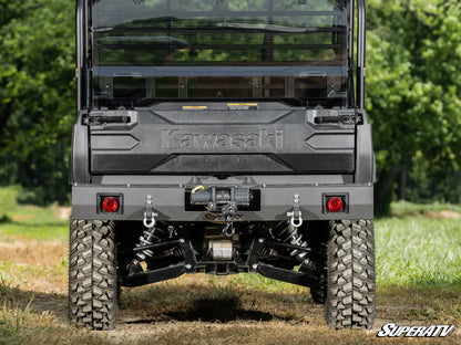 Kawasaki SuperATV vehicle shown from the rear with a forest background