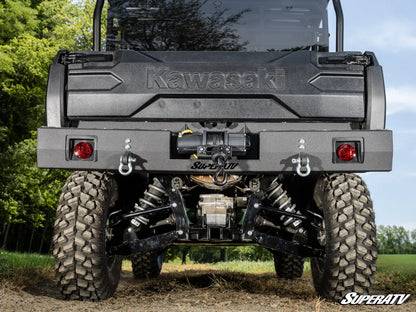 Kawasaki SuperATV vehicle with large tires and visible branding in an outdoor setting.