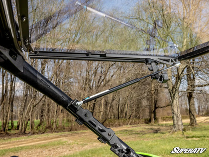 Close-up of a SuperATV product with trees and sky in the background