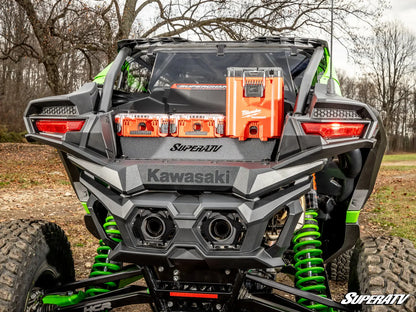 Kawasaki SuperATV vehicle with green suspension in a natural setting