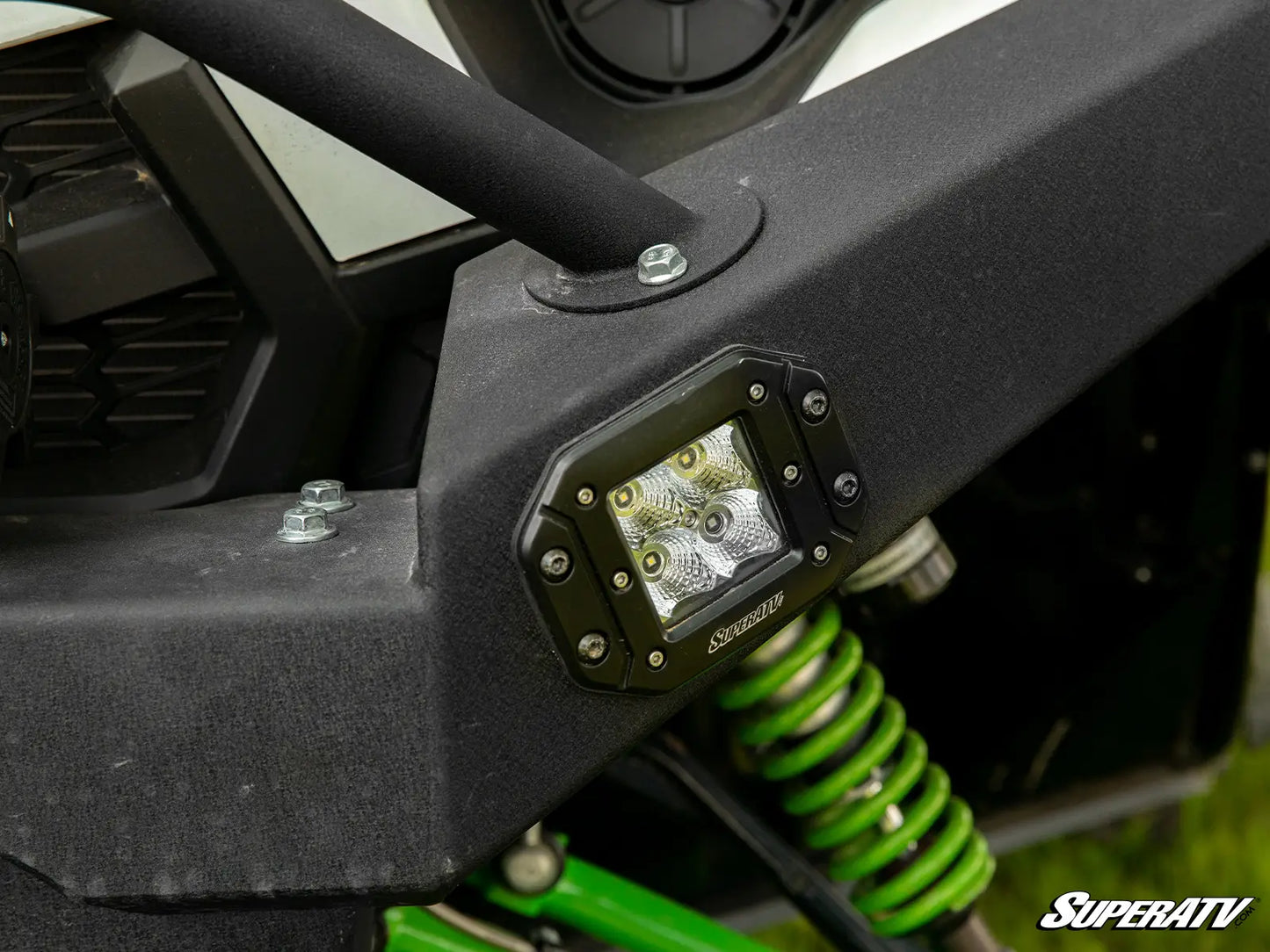 Close-up of a vehicle bumper with an LED light and SuperATV branding.