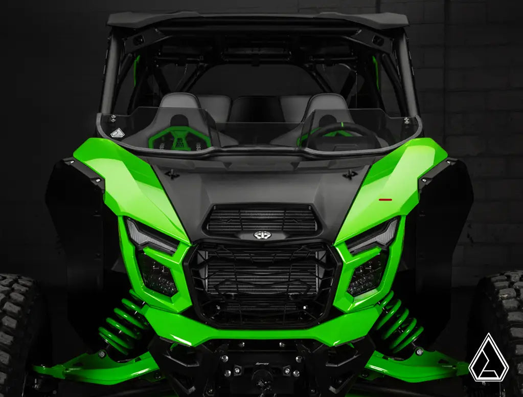 Green and black off-road vehicle with a dark background