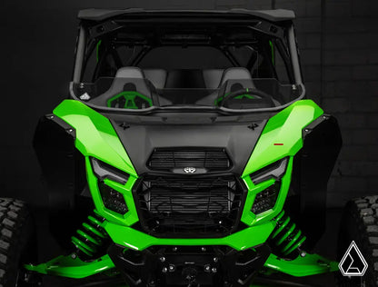 Green and black off-road vehicle with a dark background