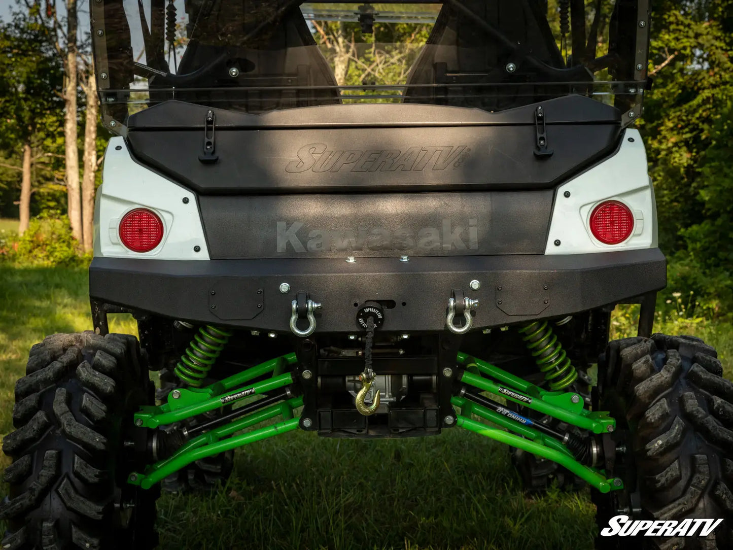 Back view of a Kawasaki ATV with SuperATV branding on a grassy background