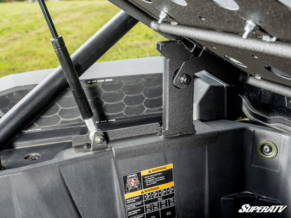 Close-up of a SuperATV product with a warning label on a vehicle's roof rack.