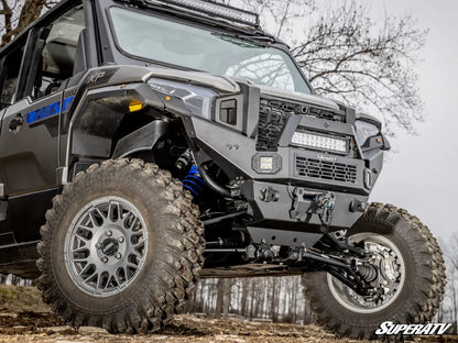 Off-road vehicle with large tires and visible SuperATV branding on a natural background.