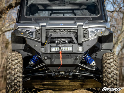 Front view of a rugged vehicle with off-road tires and suspension system, featuring SuperATV branding.