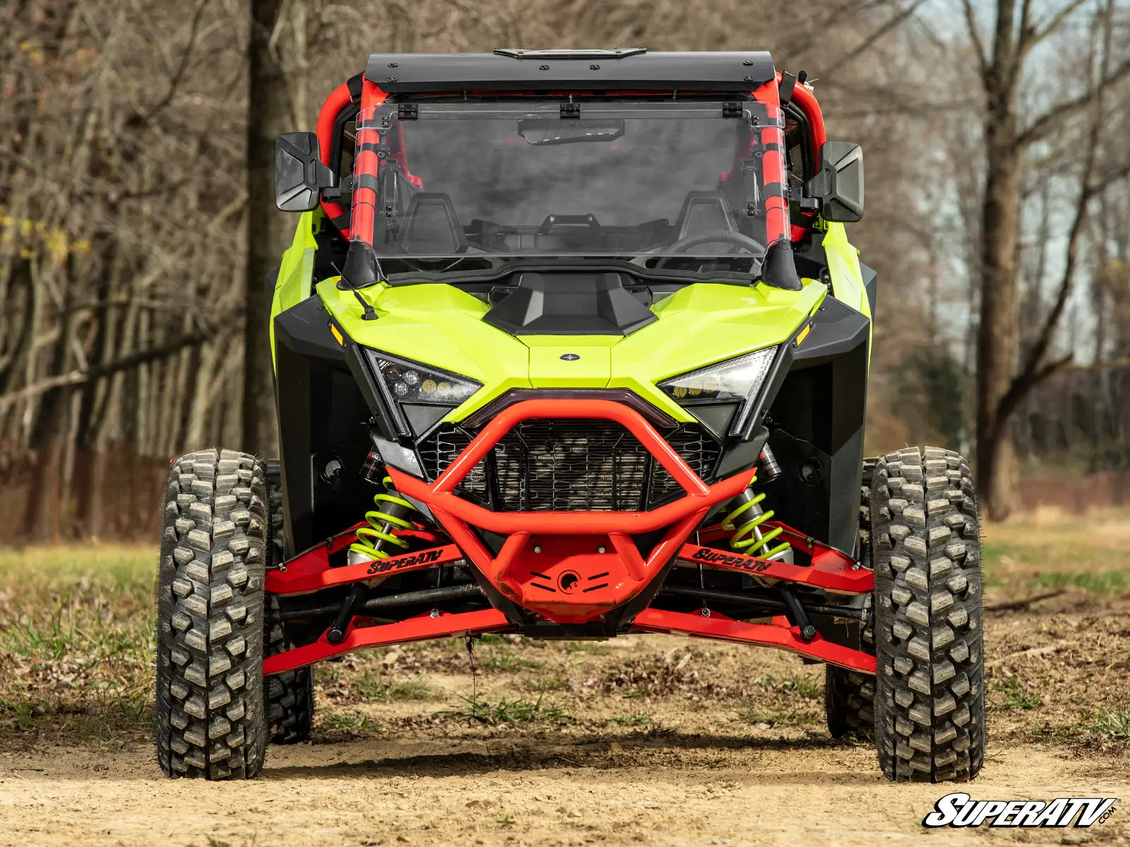 Yellow and red off-road vehicle in a forest setting