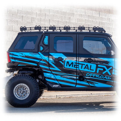 Blue off-road vehicle with 'Metal FX Offroad' branding parked against a brick wall.