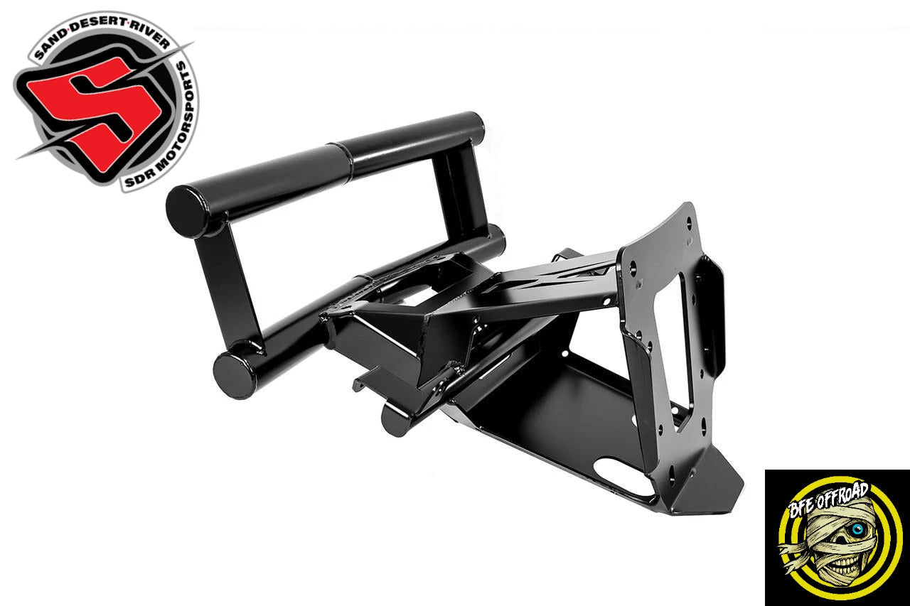 A black metal mounting bracket or frame component shown on a plain white background, with two circular brand logos in the corners: Sand Desert River Side Motorcycle Shop in the top-left and BFE Offroad in the bottom-right.
