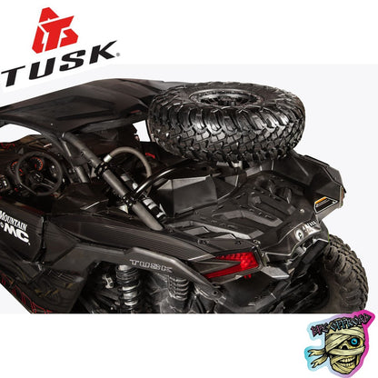 A black Tusk RC crawlerside remote control vehicle with a spare tire mounted on the rear frame, shown from a high-angle rear view against a white background. The Tusk logo is visible in the top left corner, and a 'BFE Offroad"  Logo is in the bottom right.