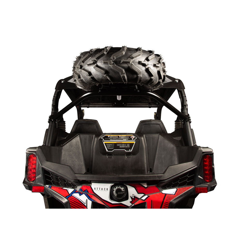 Rear view of a black off-road utility vehicle with a large black tire mounted on the roof rack, shown against a plain white background.