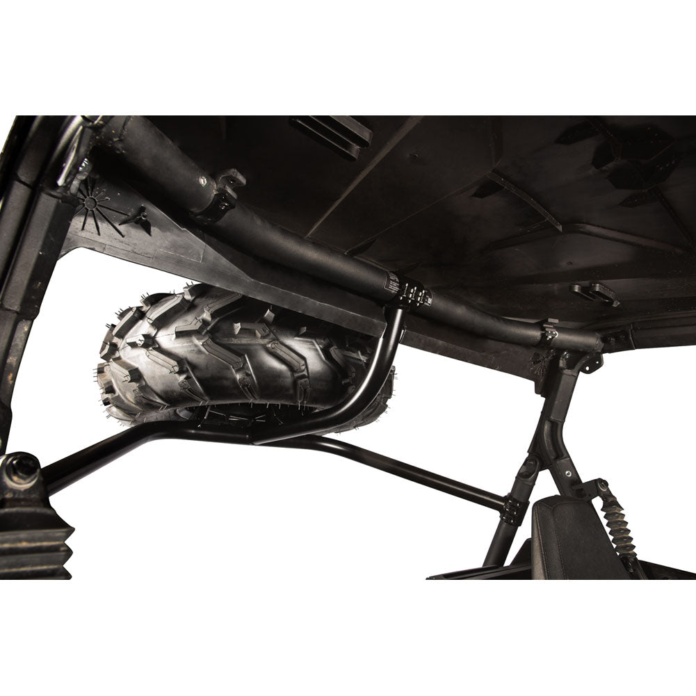 Black metal undercarriage crossmember and roll bar assembly mounted over an all-terrain vehicle tire, shown against a white background.