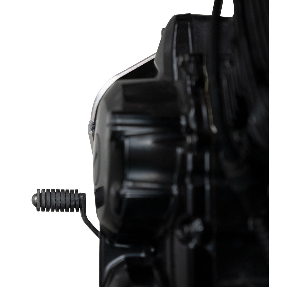 Close-up of a black motorcycle engine component and footpeg against a white background.