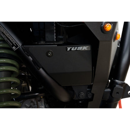 Close-up of a motorcycle with 'Tusk' branding on a white background