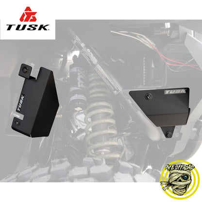 Tusk suspension components on a blurred off-road vehicle background with Tusk logo.