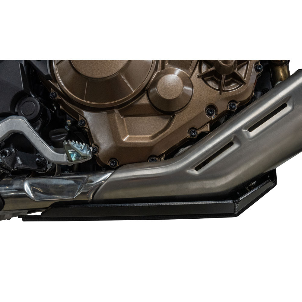 A close-up of a motorcycle engine and exhaust system with a black side cover or shield, shown against a plain white background.