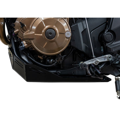 Close-up of a black engine cover and side panel on a motorcycle engine, shown against a white background.