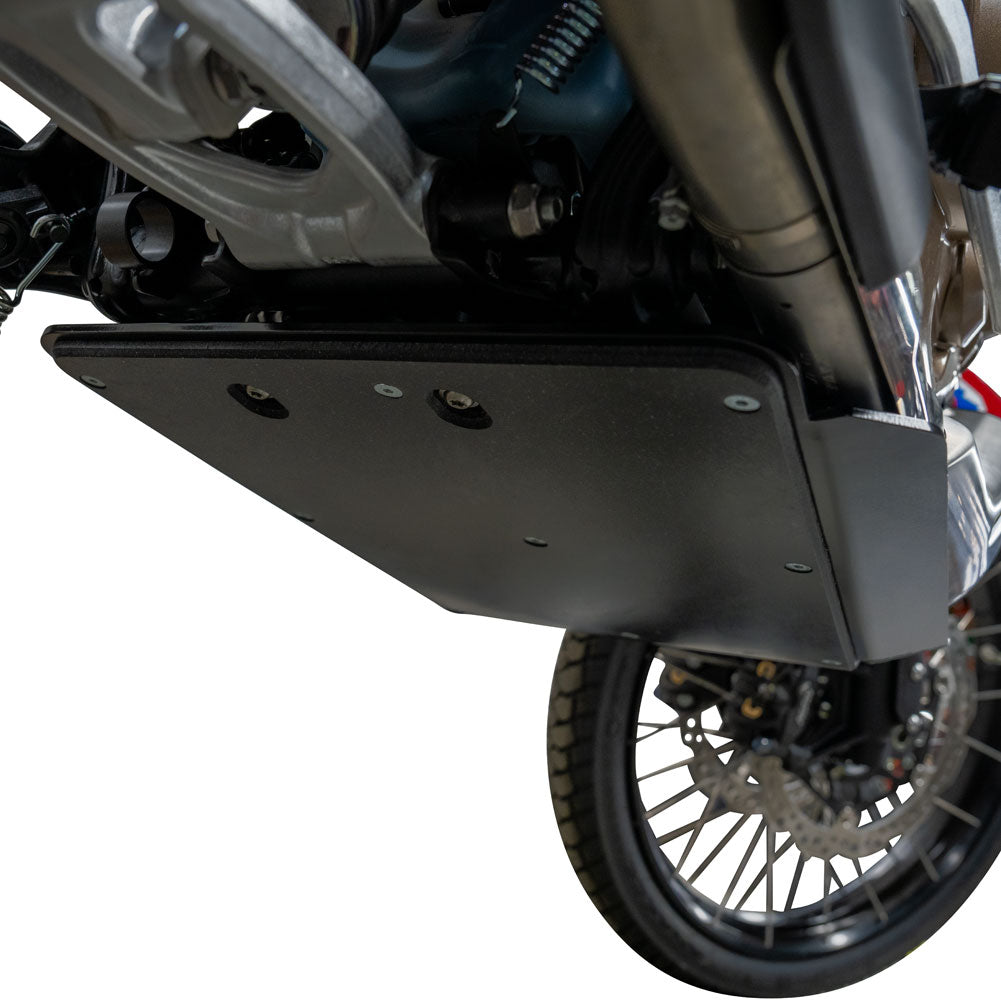 A black metal motorcycle ground shield or skid plate mounted over the engine and exhaust area, shown installed on a motorcycle against a white background.