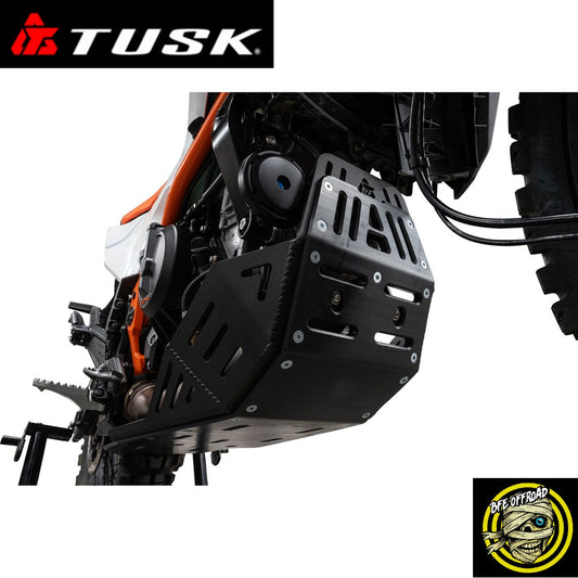 A black metal engine guard and skid plate protector mounted on an off-road motorcycle, shown against a white background with a Tusk brand logo in the top-left corner and a BFE Offroad logo in the bottom-right corner.
