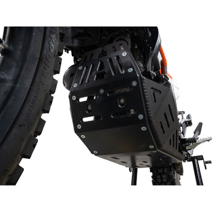 Black metal engine and exhaust protection guard mounted on a motorcycle, shown against a white background.